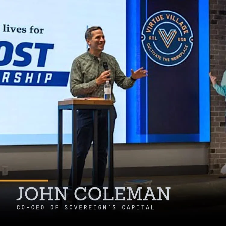 John Coleman, co-CEO of Sovereign's Capital, speaking at a podium during a presentation with a large screen behind him displaying the Virtue Village logo and a slogan about cultivating the workforce.
