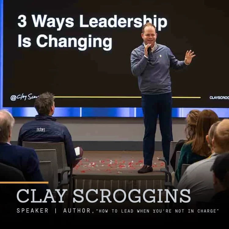 A man standing on a stage giving a presentation titled '3 Ways Leadership Is Changing' to an audience in a conference room.