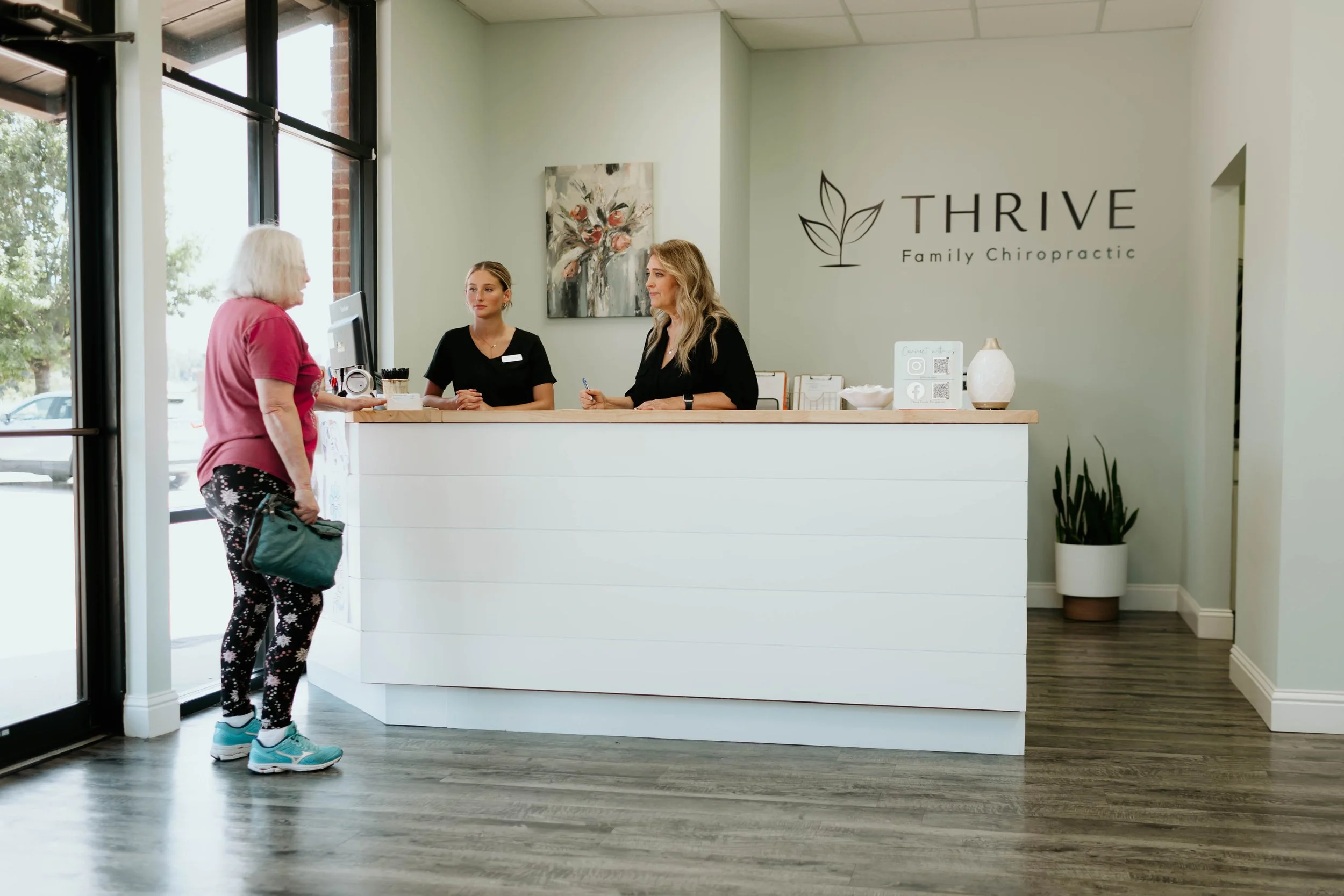 Patient being greeted at the front desk for a consultation at Thrive Family Chiropractic in Montgomery AL