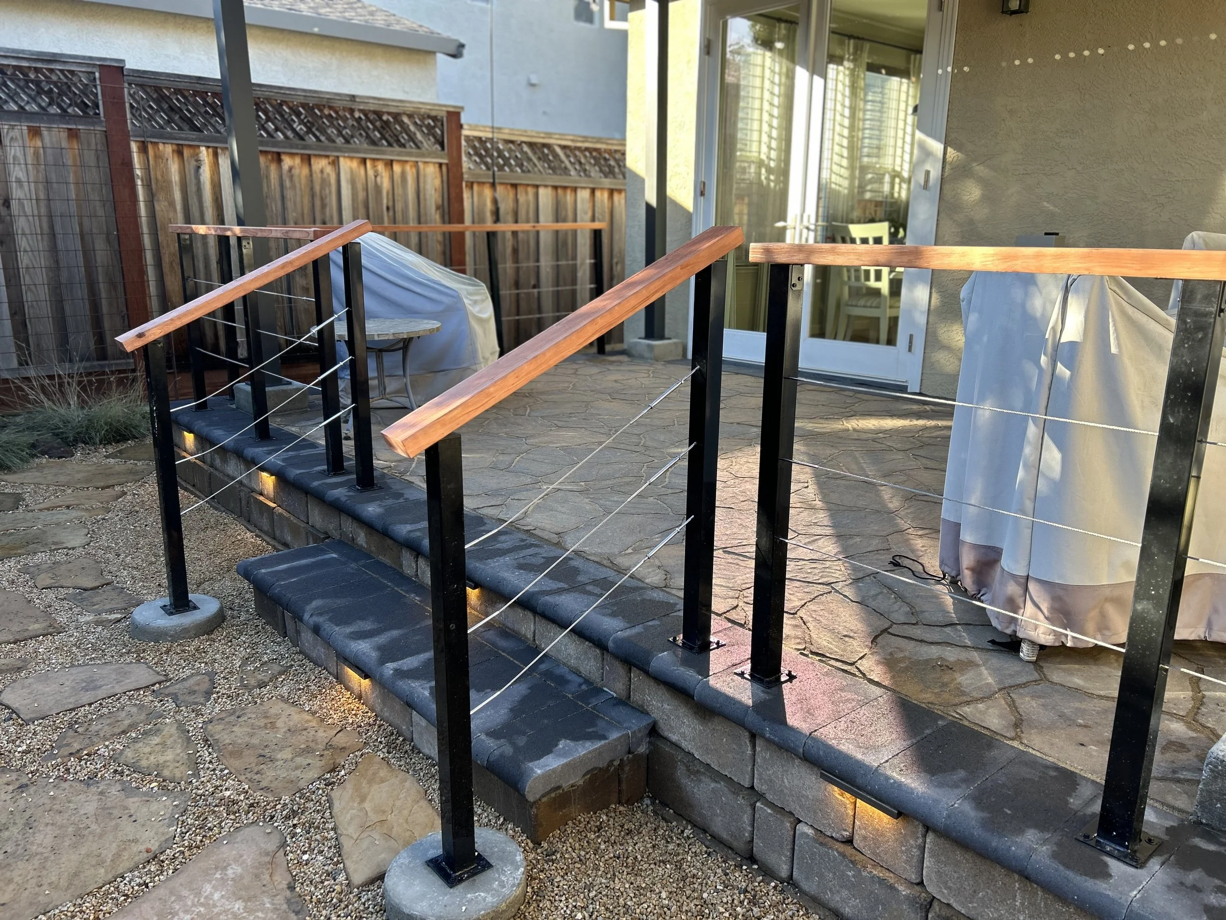 redwood wire hand railing and paver patio