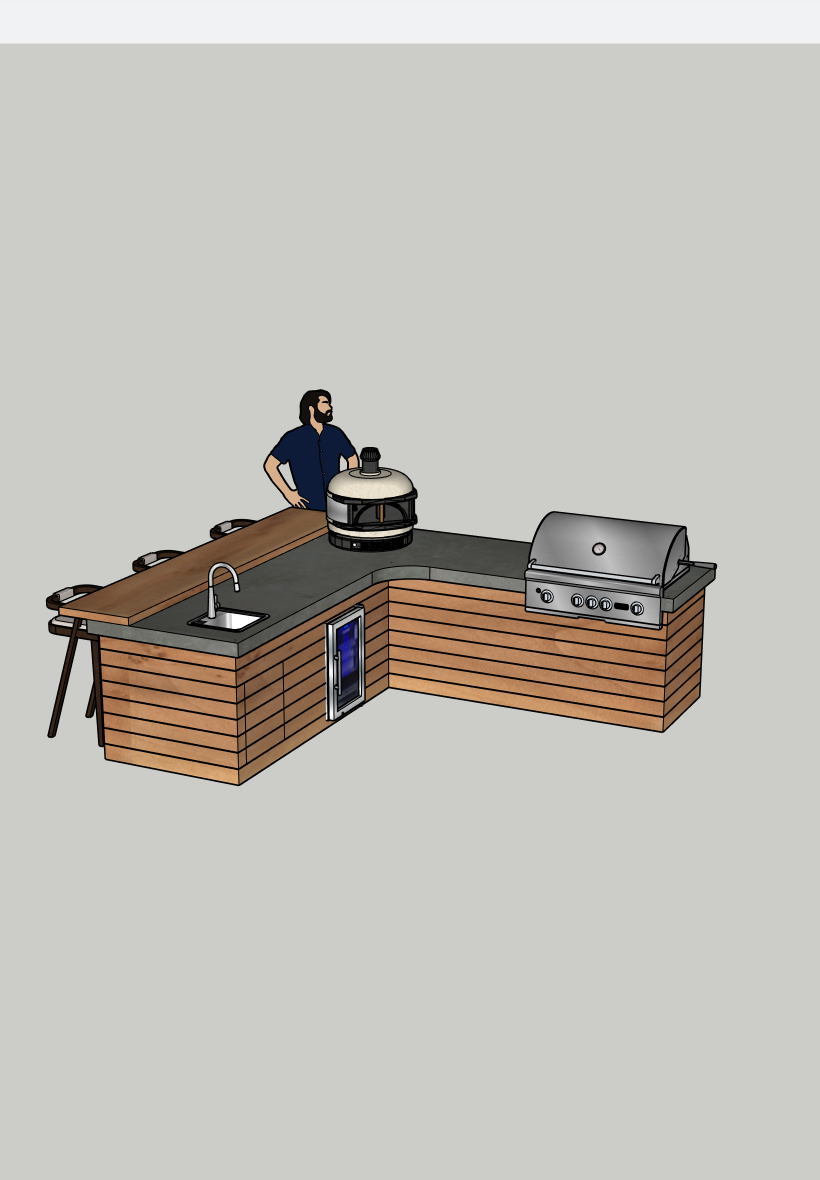 A man standing next to an outdoor kitchen island with a built-in sink, charcoal grill, and a round smoker oven, set against a plain background.