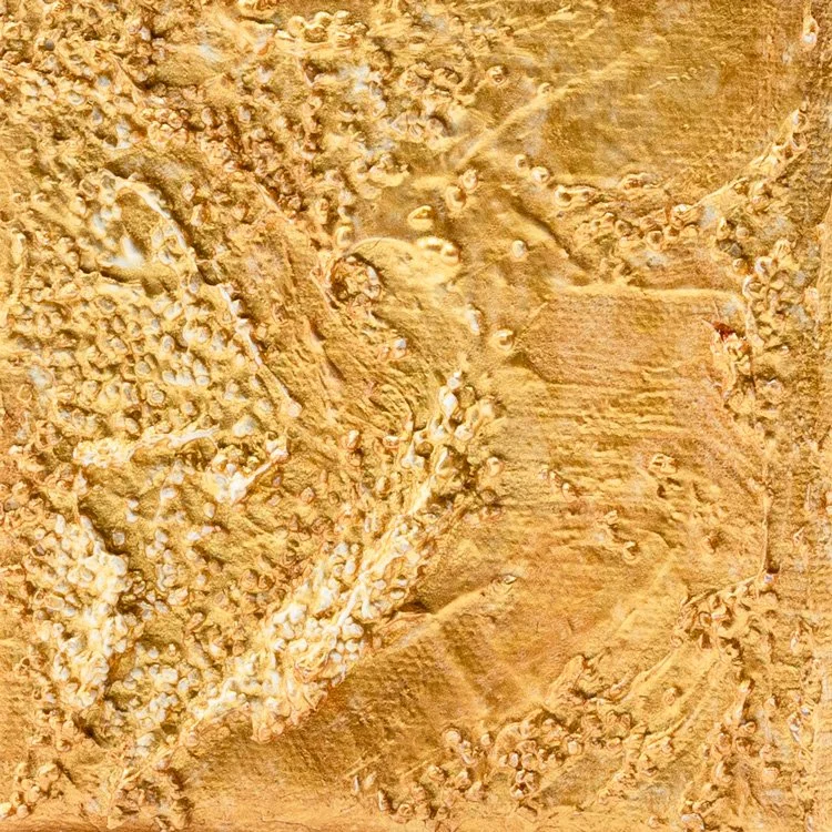 Close-up of textured sandy surface with small pebbles and ridges in tan and light brown colors.