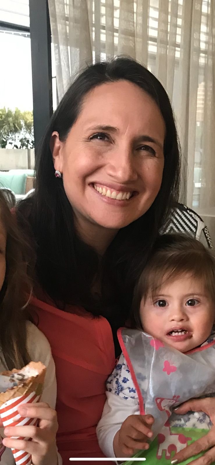 Blurred photo of heart-shaped bokeh lights in pink and white, with some dark and yellowish background elements.