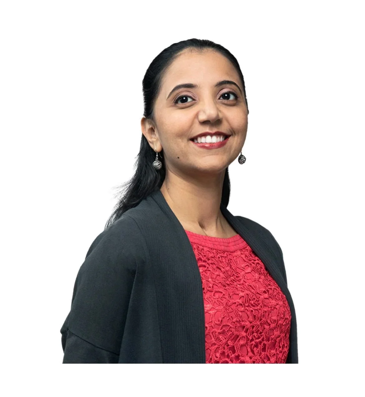 Portrait of a woman with dark hair, smiling, wearing earrings, a black blazer, and a red lace top, against a plain white background.