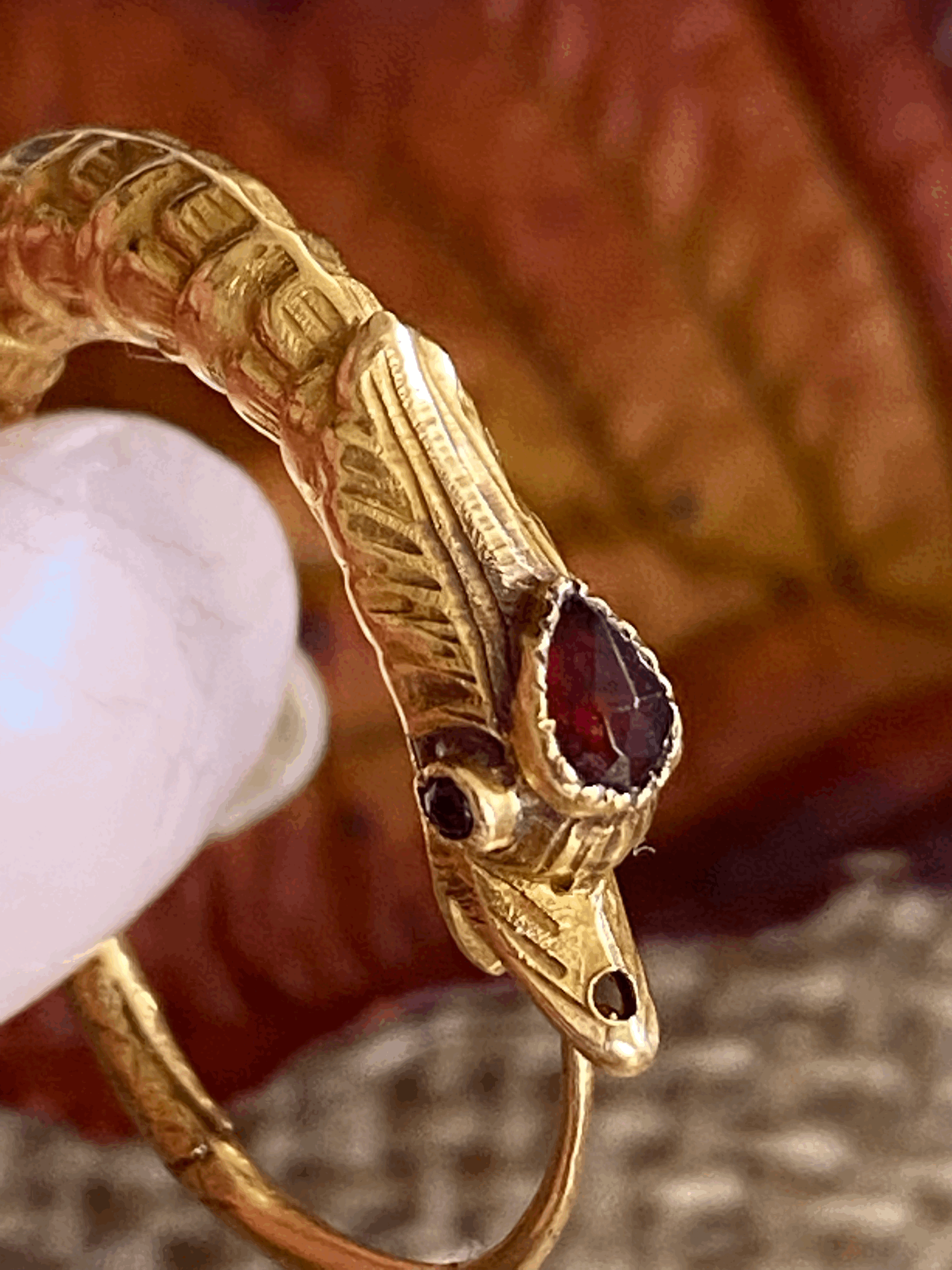 Ouroboros earrings with garnet head , 18ct gold