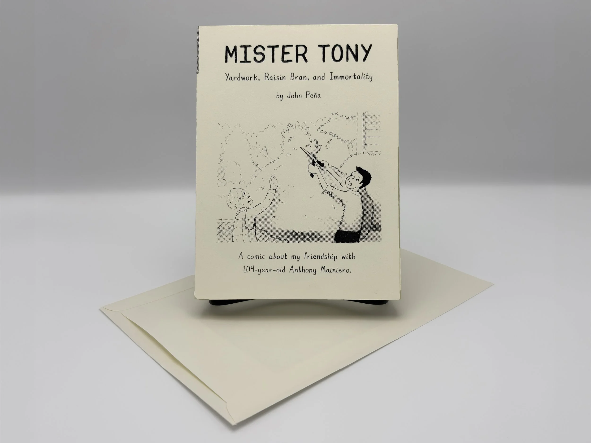 Front of Stonehenge printed Book with screenprinted text resting on top of an archival envelope.