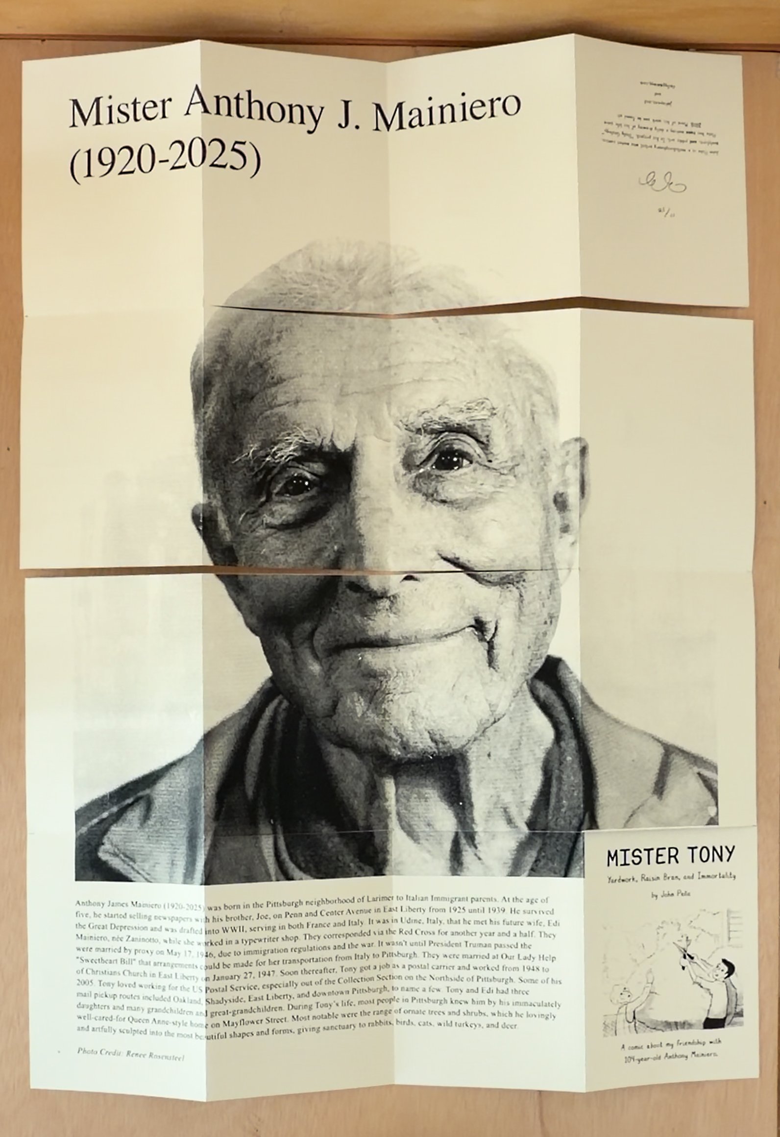 Book completely unfolded to reveal a portrait of Mister Tony a 104 year old man with text at the bottom describing his life.
