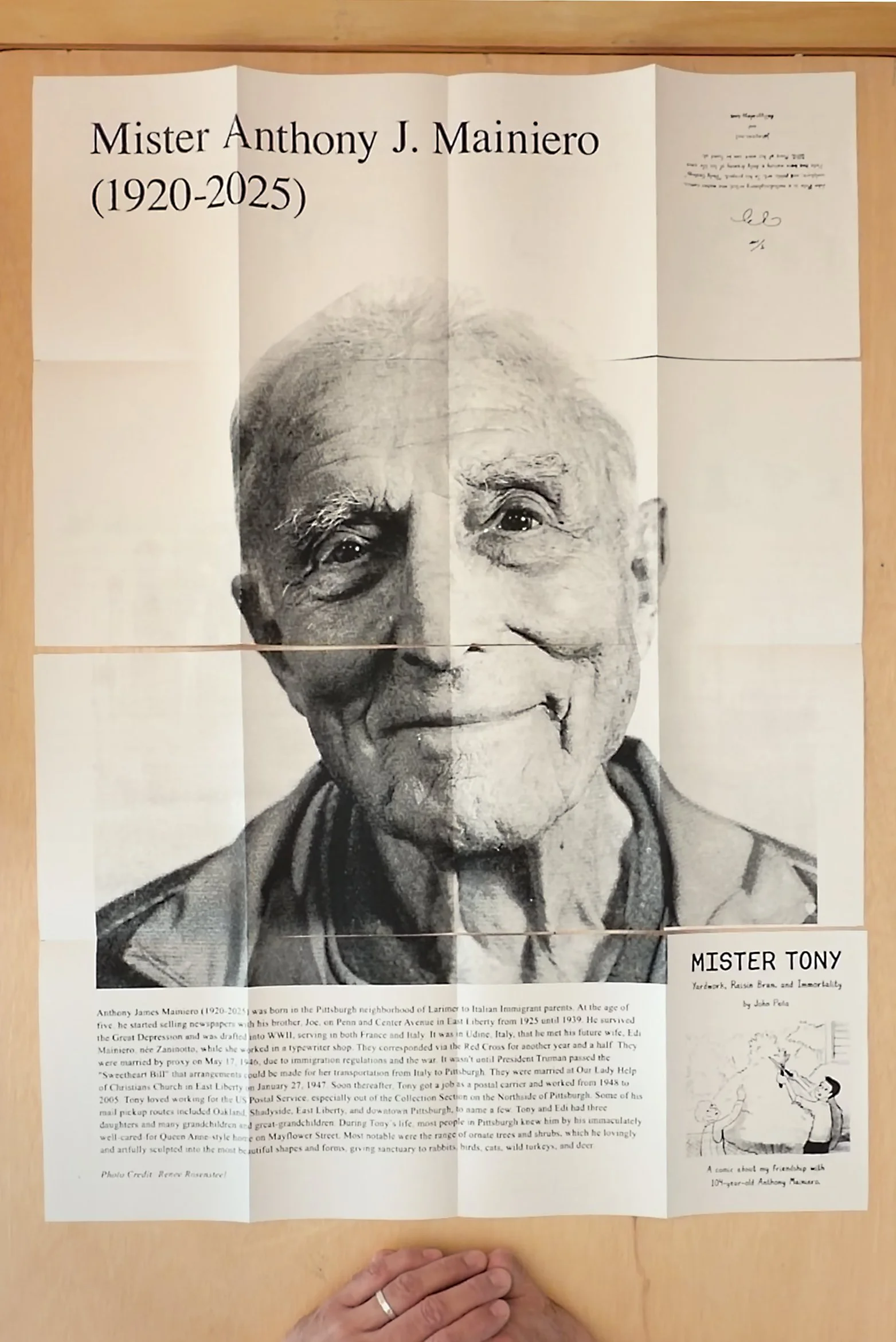 Book completely unfolded to reveal a portrait of Mister Tony a 104 year old man with text at the bottom describing his life.