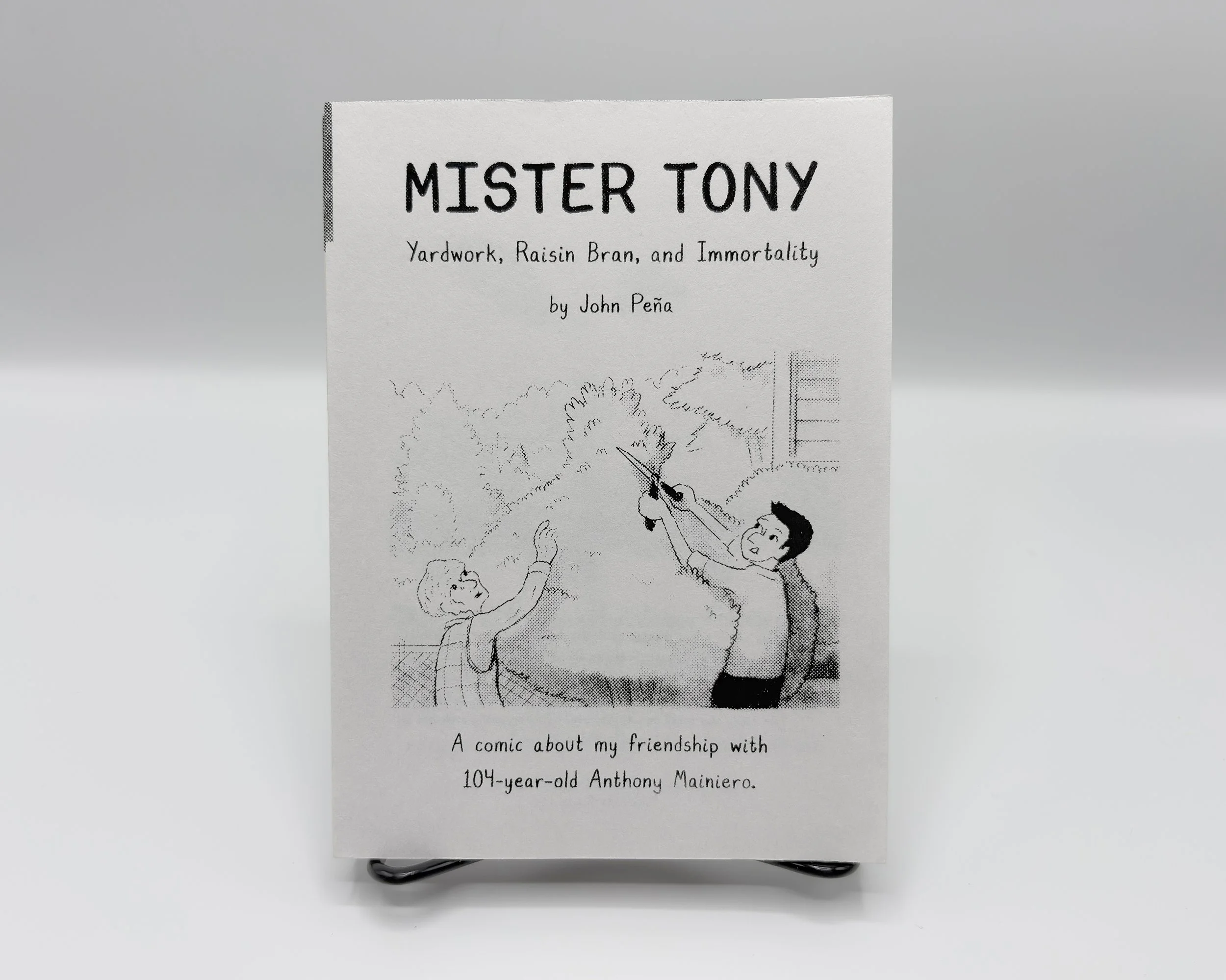 Newsprint Book with screenprinted text containing two individuals pruning a tree
