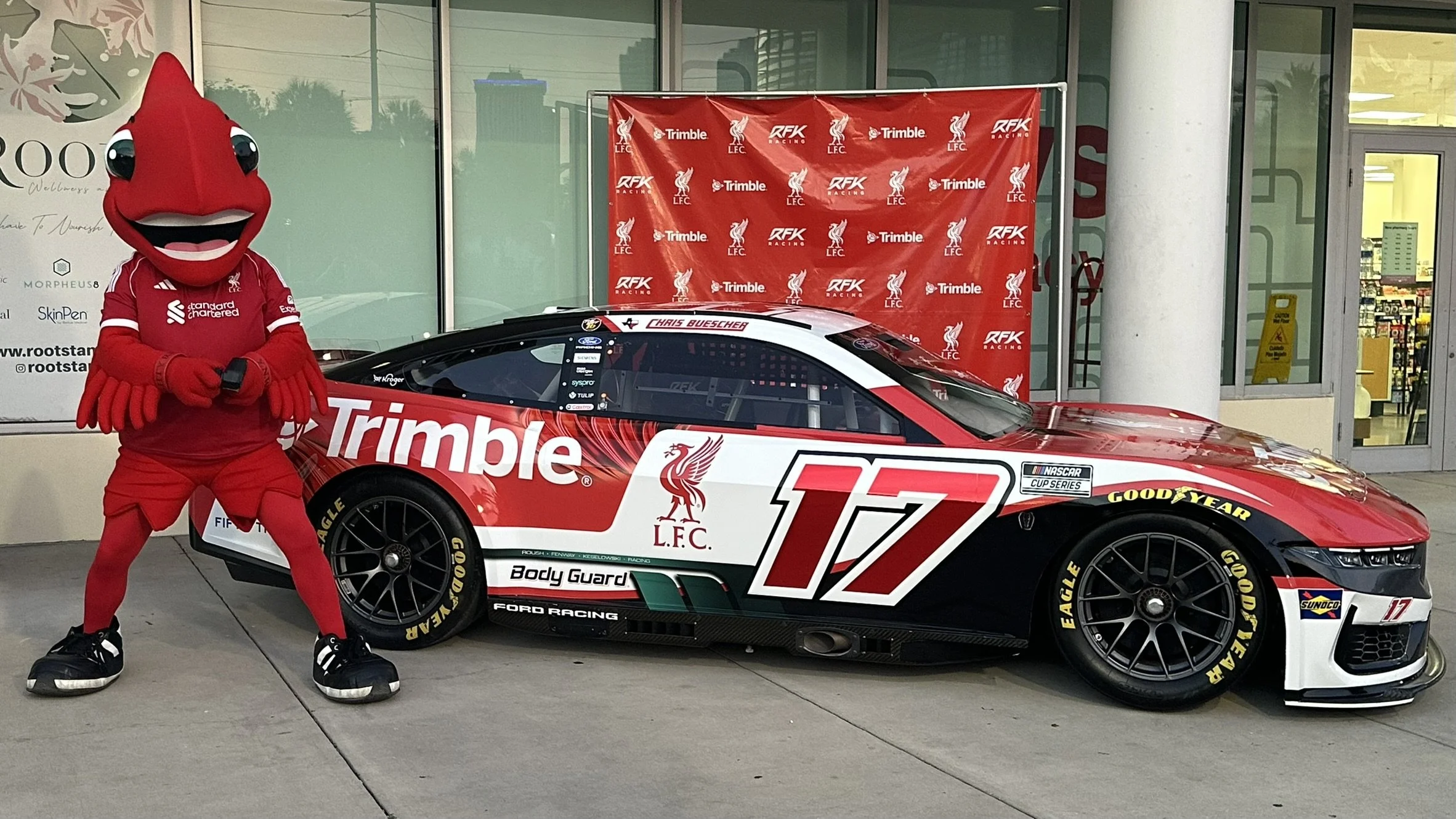 Liverpool FC Mascot Mighty Red with Nascar Cup Series RFK Racing Ford Mustang Dark Horse Trimble LFC Number 17 Driven by Chris Buescher at Sonoma Raceway Liverpool Official Supporters Club of Tampa Bay OLSC