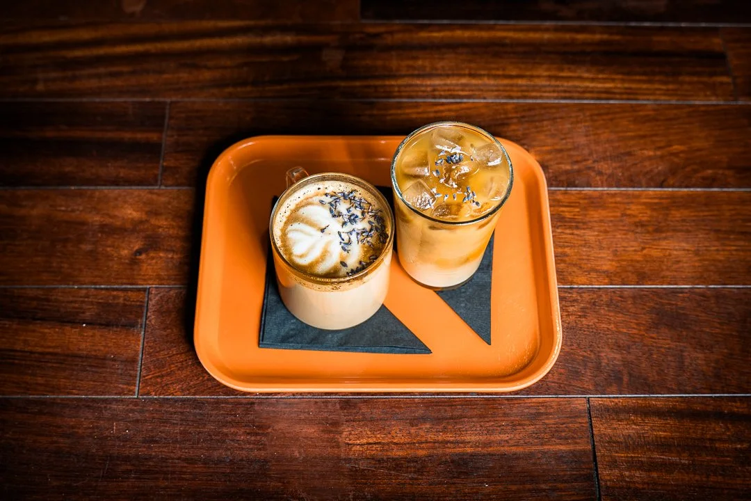 Two iced coffees on a branded orange tray