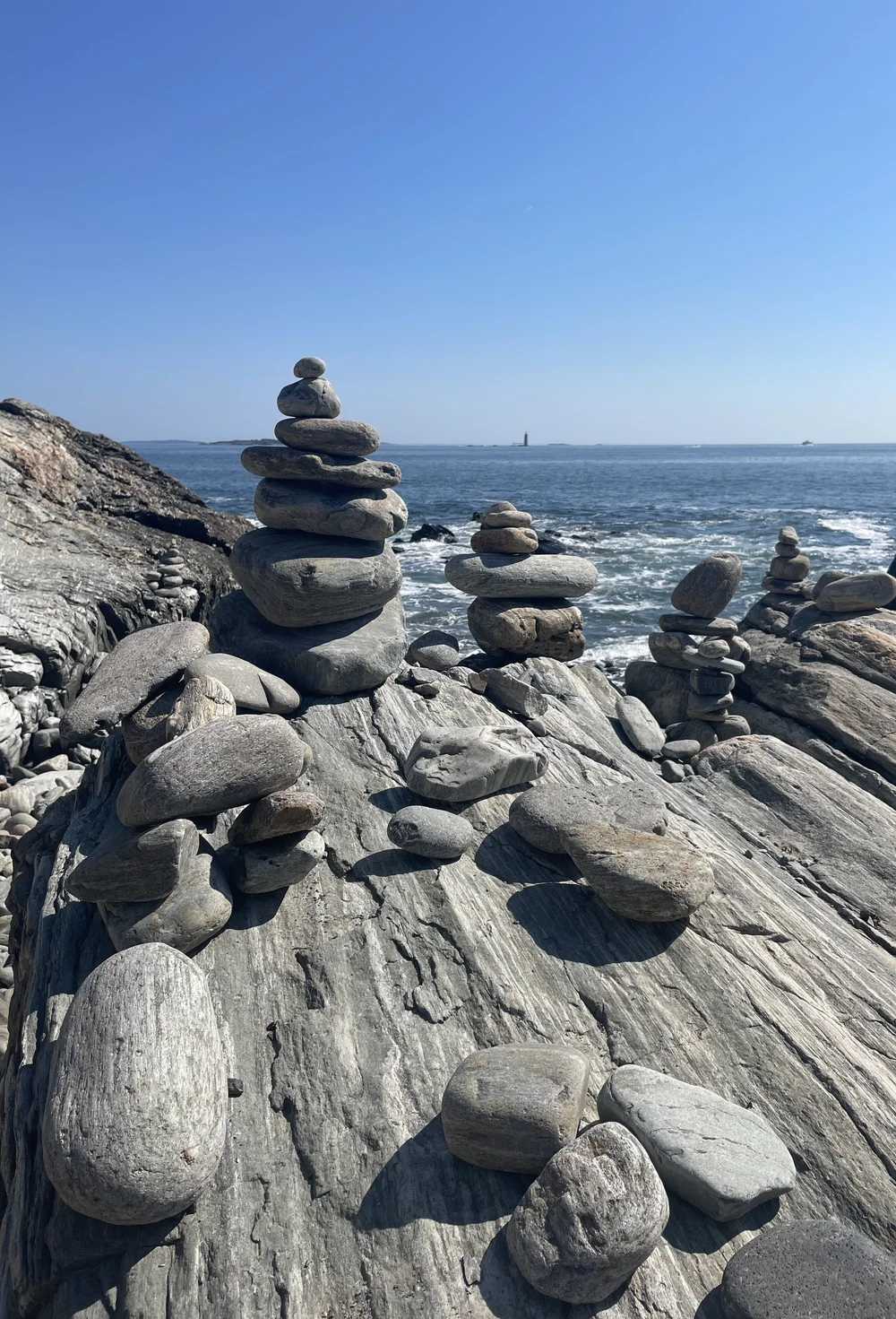 Balanced stacked stones on a rocky shore