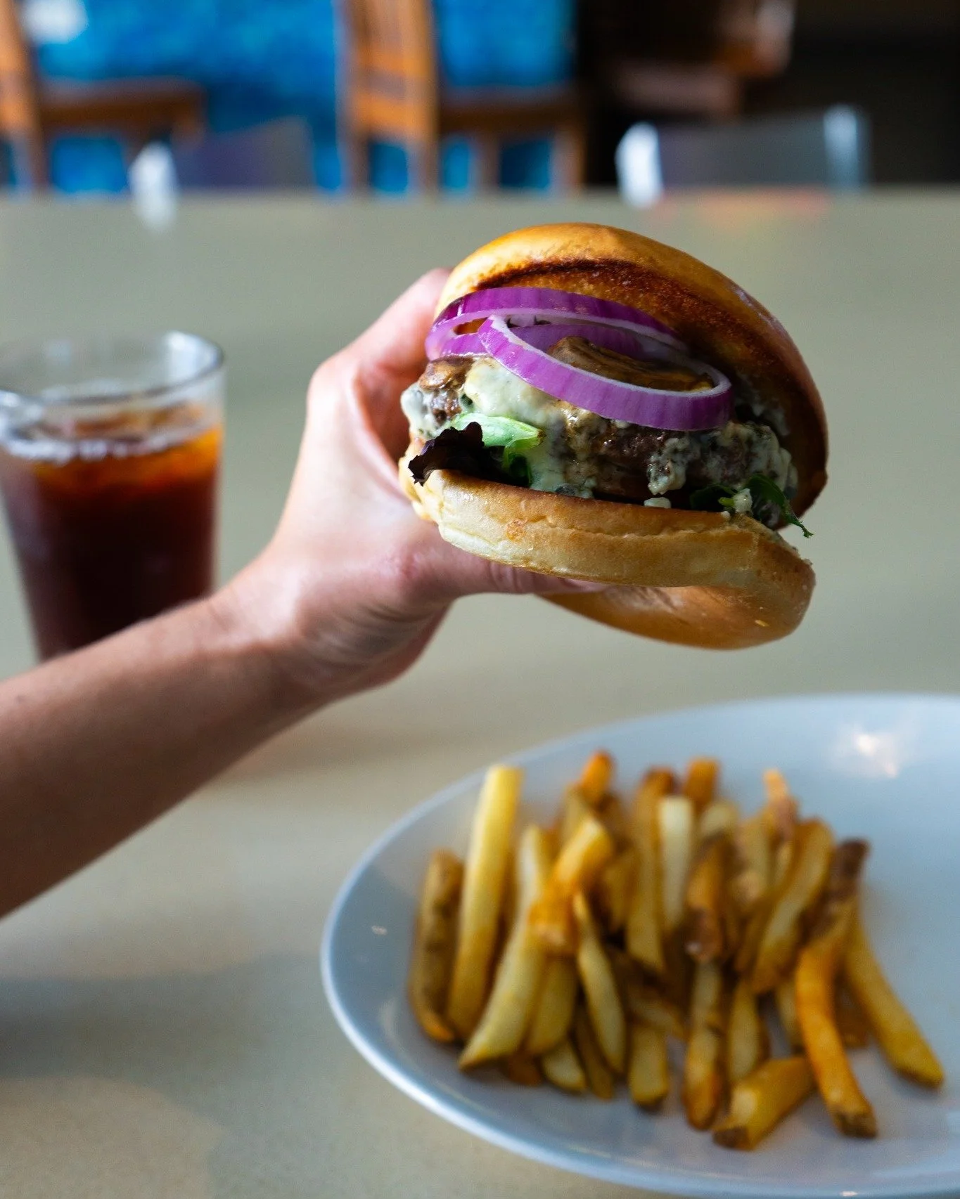 Black &amp; Blue Burger
When it comes to burgers, this one does not hold back. Imagine a perfectly blackened burger with just the right amount of spice, paired with the crunch of fresh greens and tomatoes. Add in rich blue cheese, tender mushrooms, a