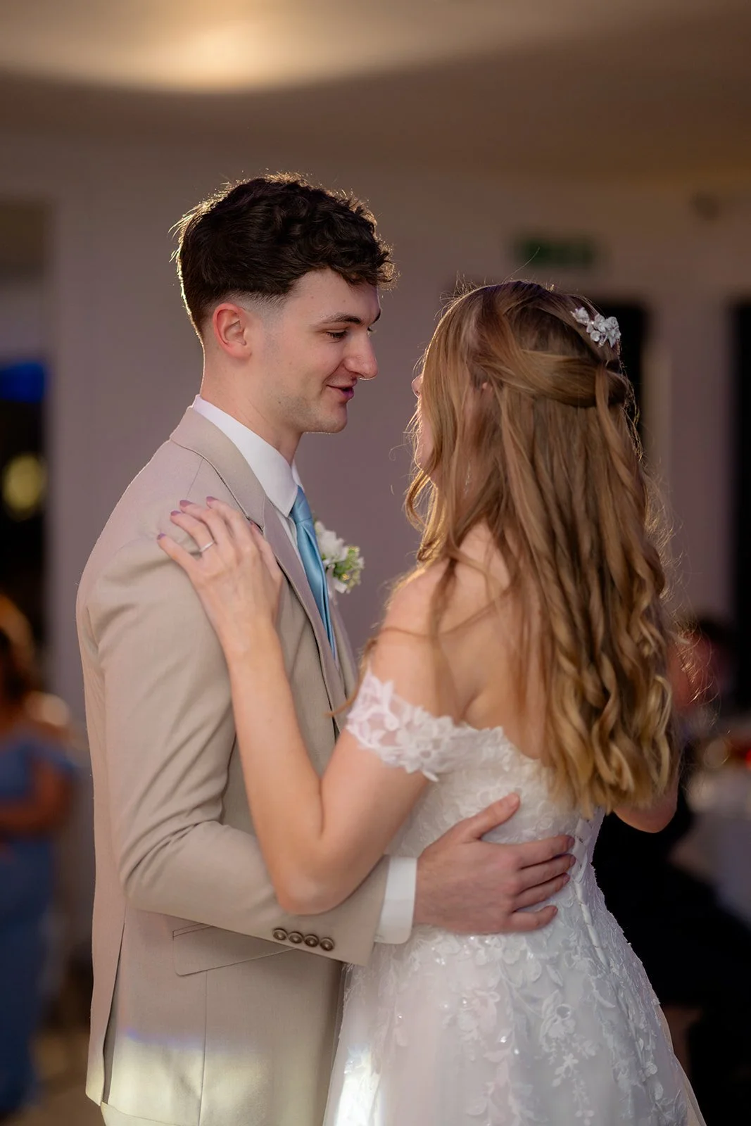 Hannah & Cameron share their first dance together during the evening reception at Sandy Cove Hotel, North Devon. The couple hold each other closely on the dance floor, celebrating a quiet moment from their coastal wedding day.