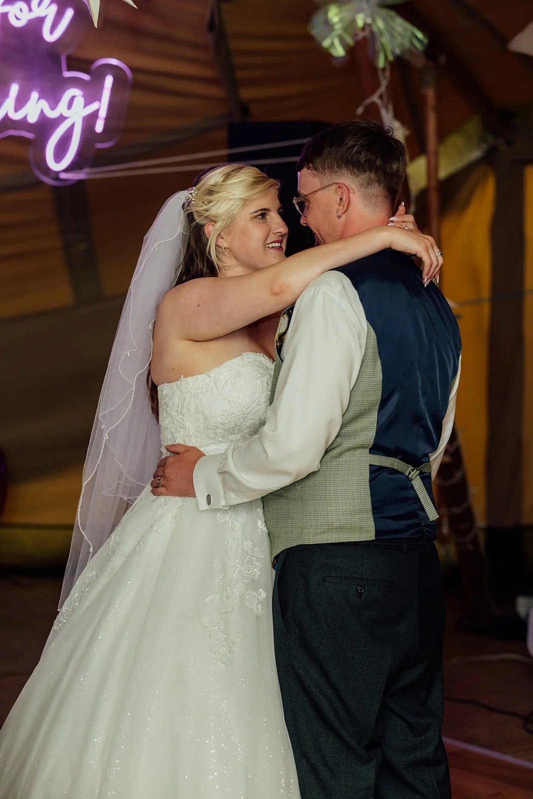 Lucy and Matthew sharing a close moment during their first dance inside the tipi reception at Curated Canvas at Noah’s Pond in Somerset, photographed by Just James Weddings.
