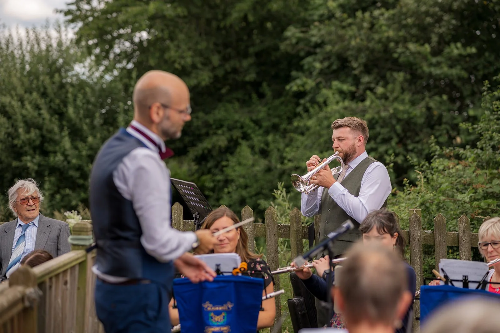Jack plays the trumpet with a live classical band during the outdoor wedding celebrations at Rock Village Hall in Worcestershire, photographed by Just James Weddings.