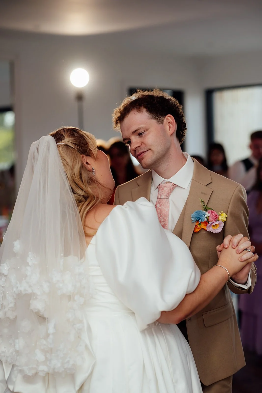 Holly & Alex share a close moment during their first dance inside Sandy Cove Hotel in North Devon, photographed by Just James Weddings.