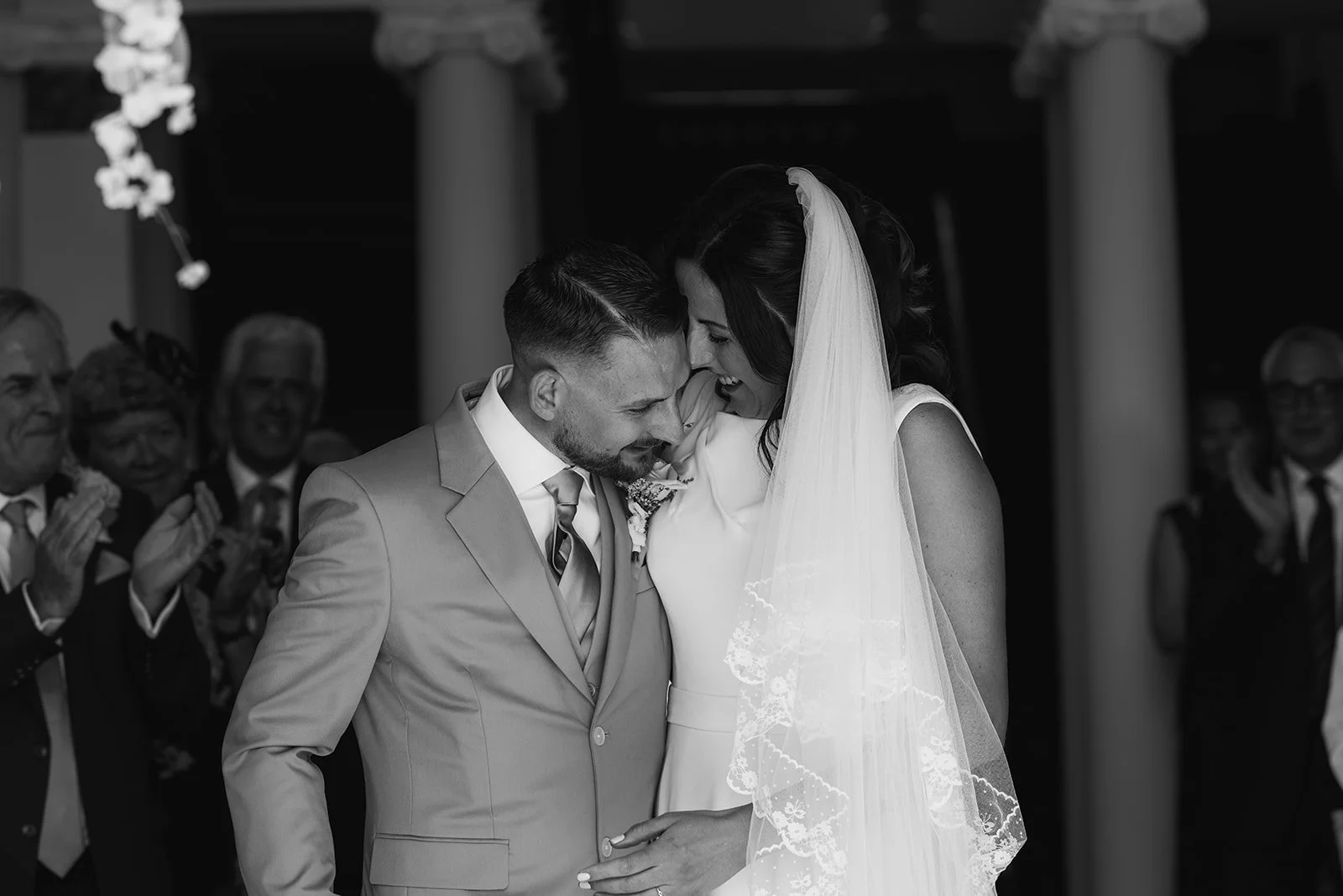 Black and white photo of Michelle and Andy sharing a close, emotional moment during their wedding ceremony at Crowcombe Court in Somerset, UK.