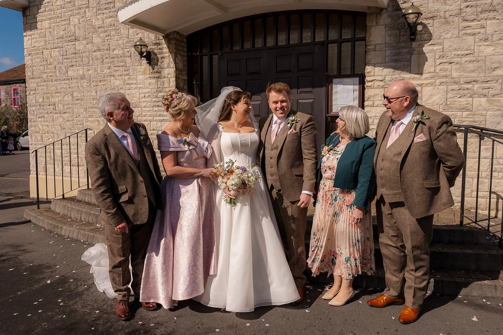 Emily & Josh pose with family outside the church after their wedding ceremony at Coombe Lodge Blagdon, Somerset, UK.