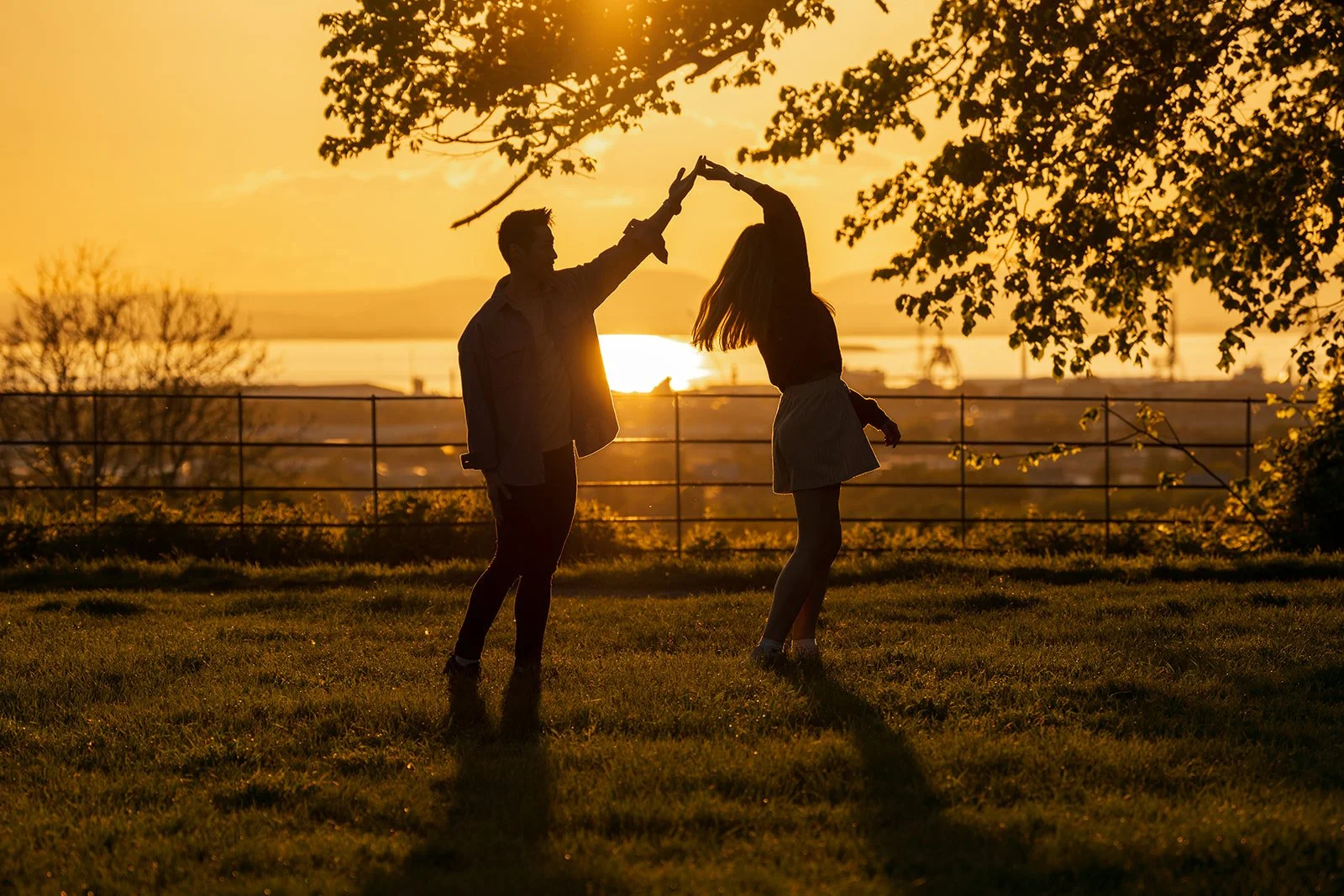 Photo of an engaged couple doing a photoshoot at sunset over the Severn Estuary in Bristol