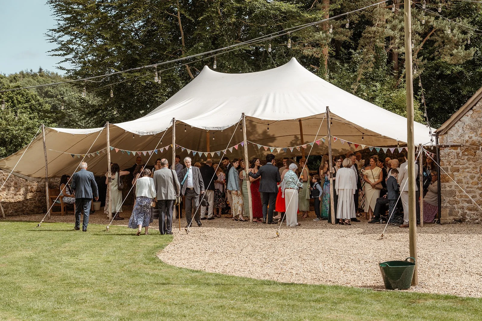 Guests gathered under an outdoor marquee at The Cider Barn in Somerset for Louise & Christian’s wedding, photographed by Just James Weddings for relaxed countryside wedding reception.