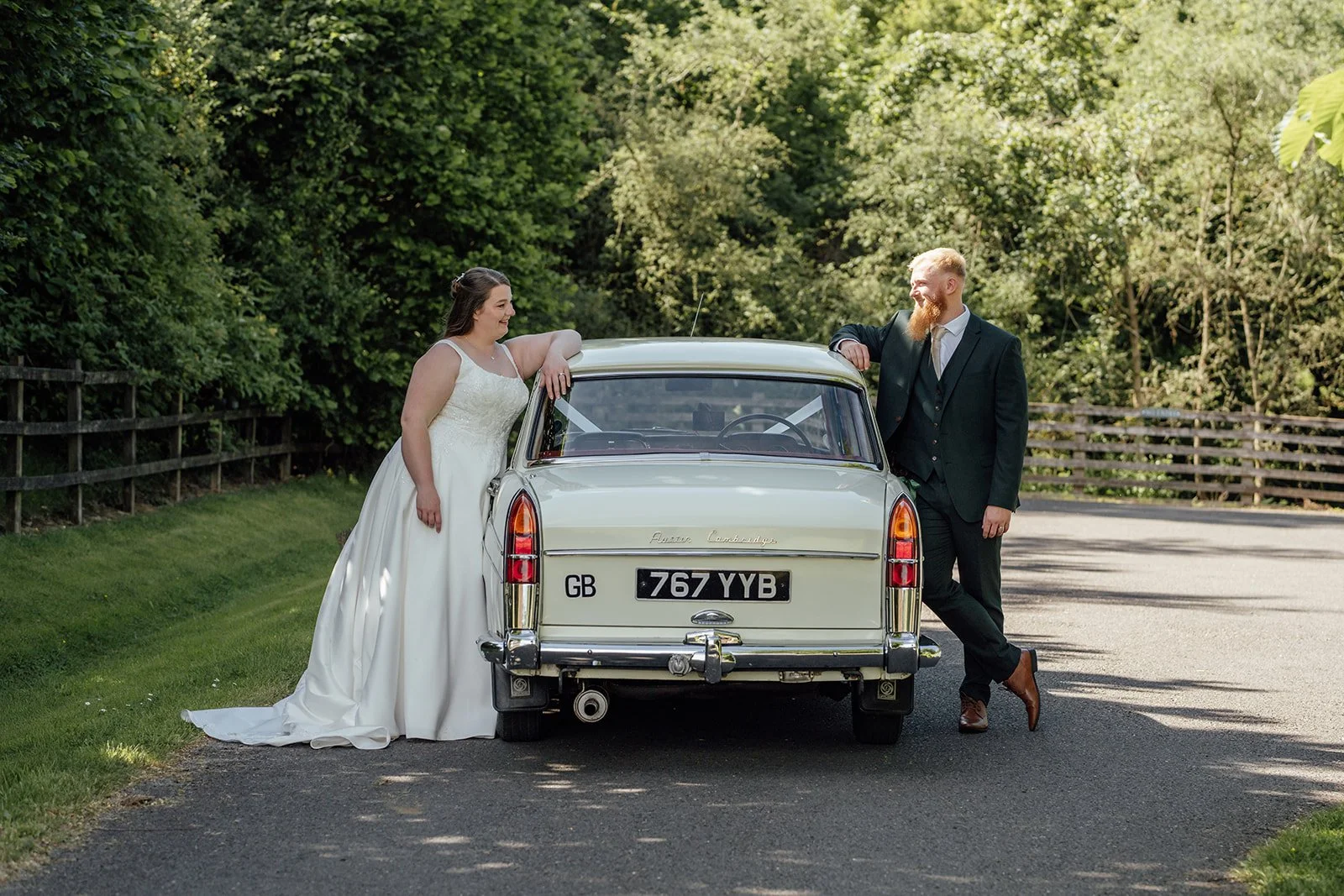 Louise and Jon posing beside a classic wedding car during their Wick Farm Bath wedding in Somerset, photographed by Just James Weddings.