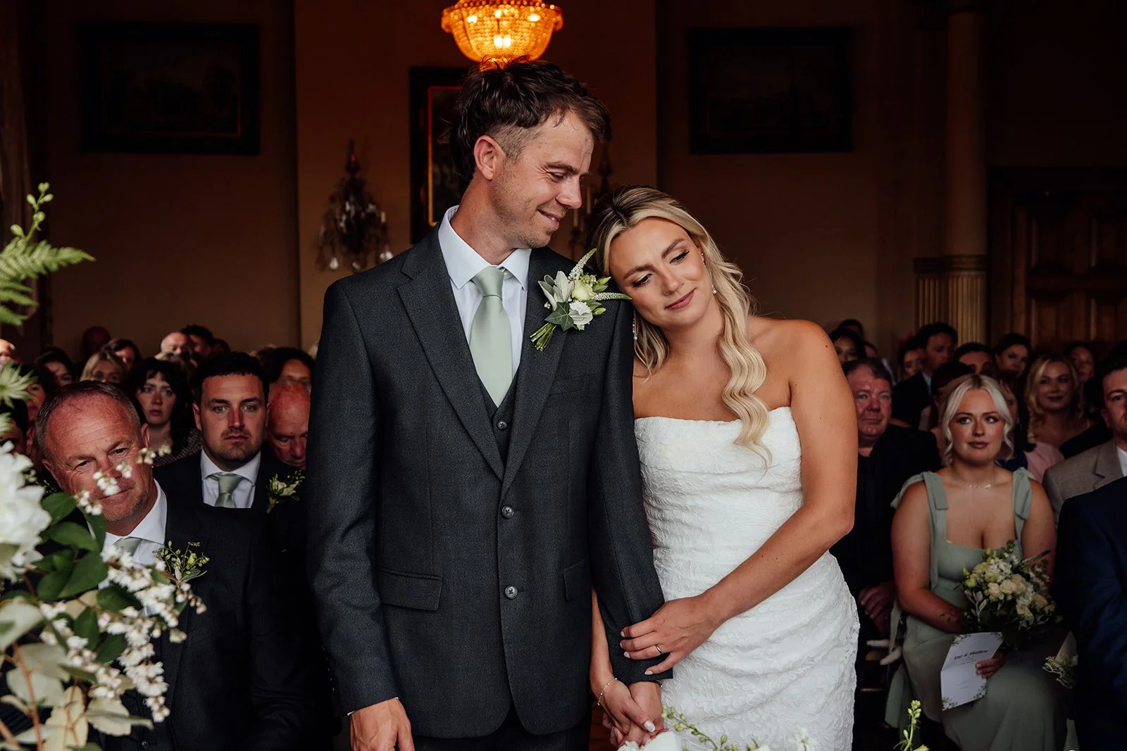 Amy resting her head on Matt during an emotional wedding ceremony at Orchardleigh Estate in Somerset, photographed by Just James Weddings.