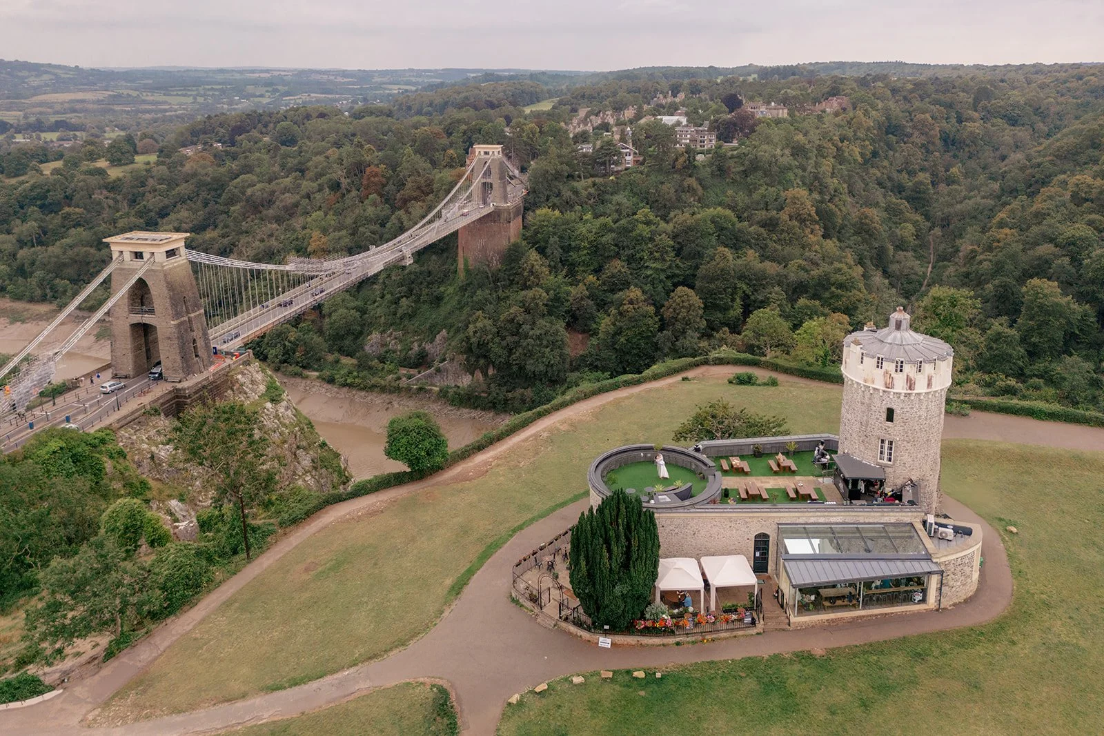 Aerial view of Clifton Observatory in Somerset, with the Clifton Suspension Bridge, terrace and surrounding greenery, photographed by Just James Weddings for wedding venue inspiration.