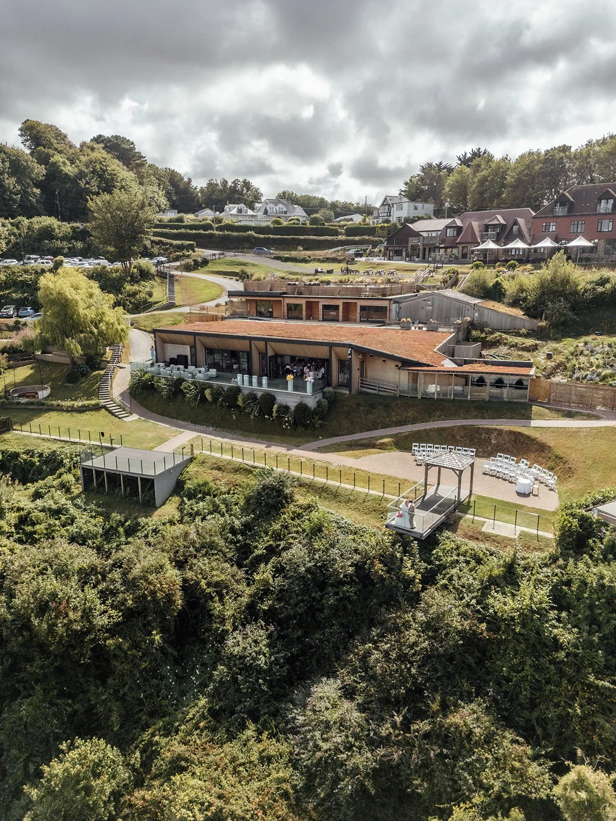 Drone view of Sandy Cove Hotel and its cliffside wedding ceremony area on the North Devon coast, photographed by Just James Weddings.