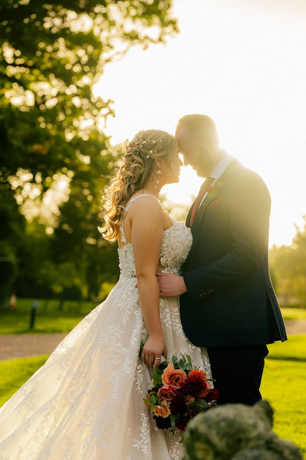 Lucy & Jay sharing a golden hour portrait in the gardens at Eastwood Park in Gloucestershire, photographed by Just James Weddings for romantic wedding photography.