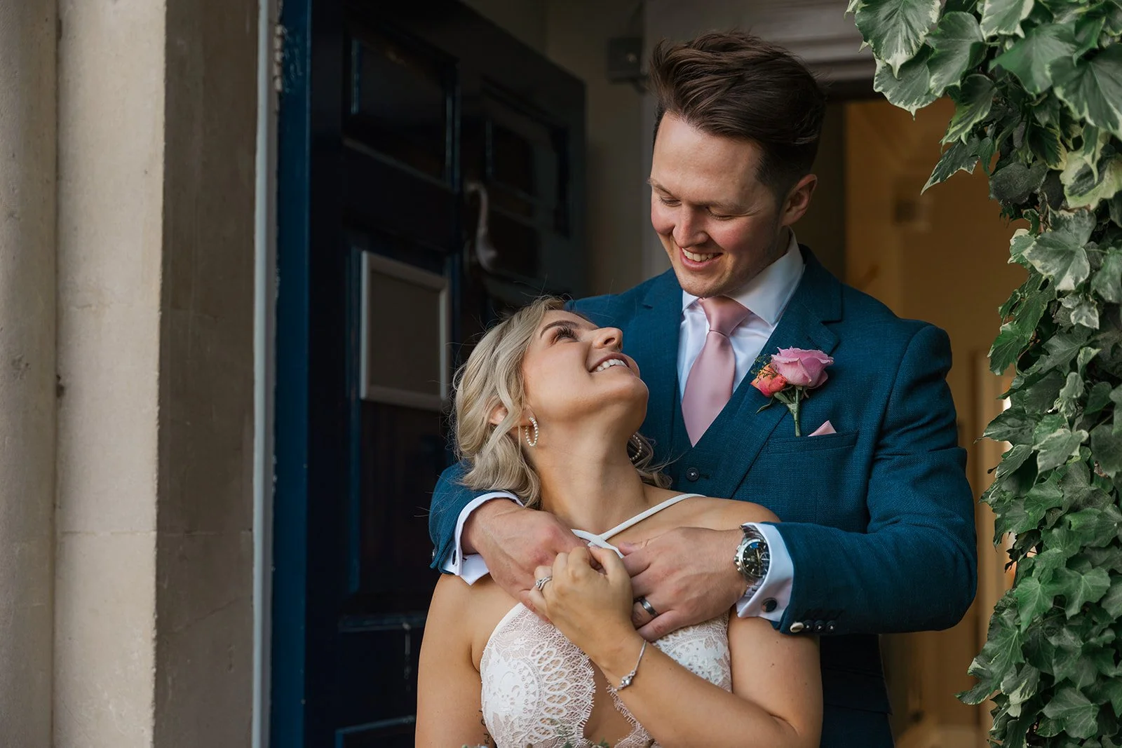 Kristy and Will share a relaxed, affectionate moment outside No. 4 Clifton Village in Bristol, UK, with Will embracing Kristy as they smile at one another.