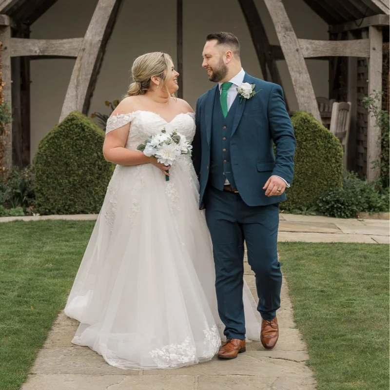 Bride and groom smiling at each other during their wedding.