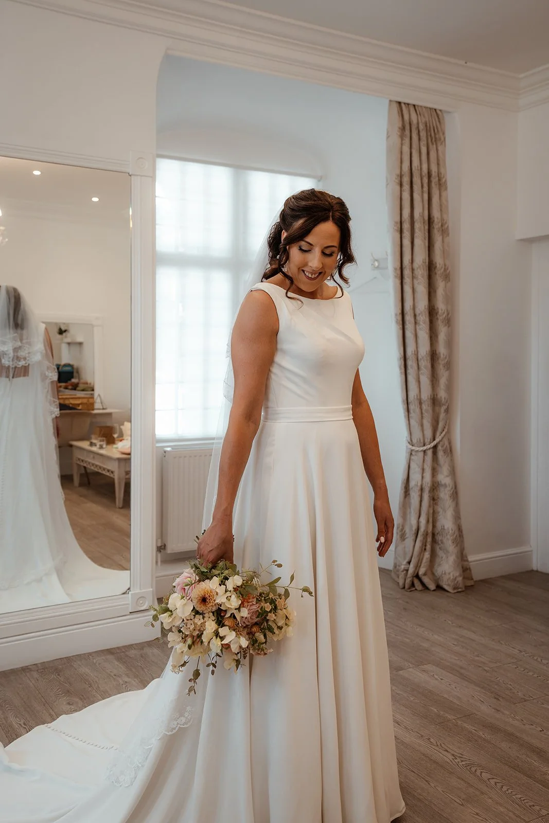 Michelle smiles while getting ready in her wedding dress at Crowcombe Court in Somerset, UK, during the quiet moments before her ceremony with Andy.