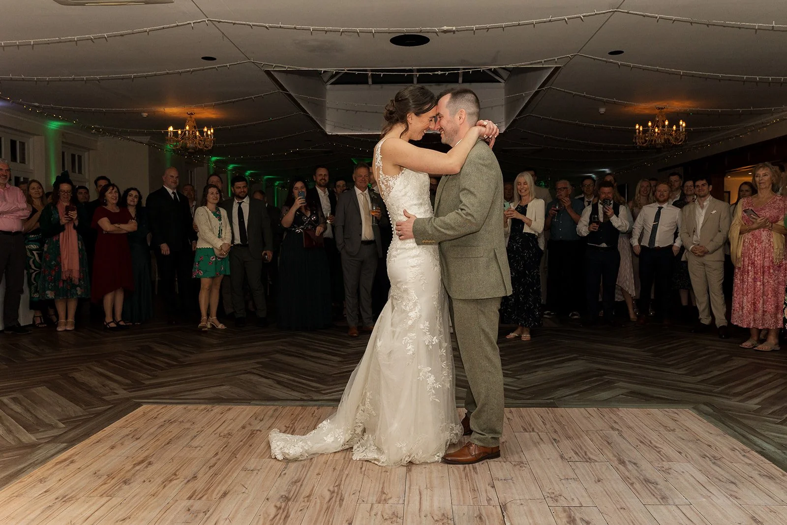 Anna & Chris share their first dance while wedding guests gather around them at Elmhay Park Weddings in Somerset, photographed by Just James Weddings.