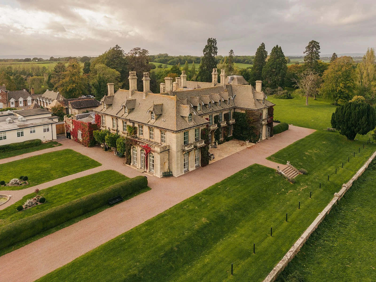 Aerial view of Eastwood Park in Gloucestershire, showing the historic manor house, gardens and countryside grounds, photographed by Just James Weddings for wedding venue inspiration.