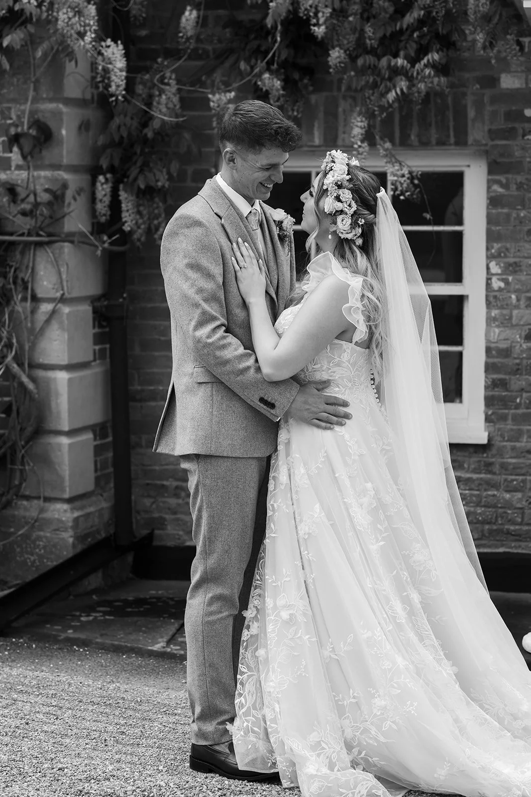 Black and white portrait of Jaye & Josh standing together at Syrencot in Wiltshire, photographed by Just James Weddings for natural romantic wedding photography.
