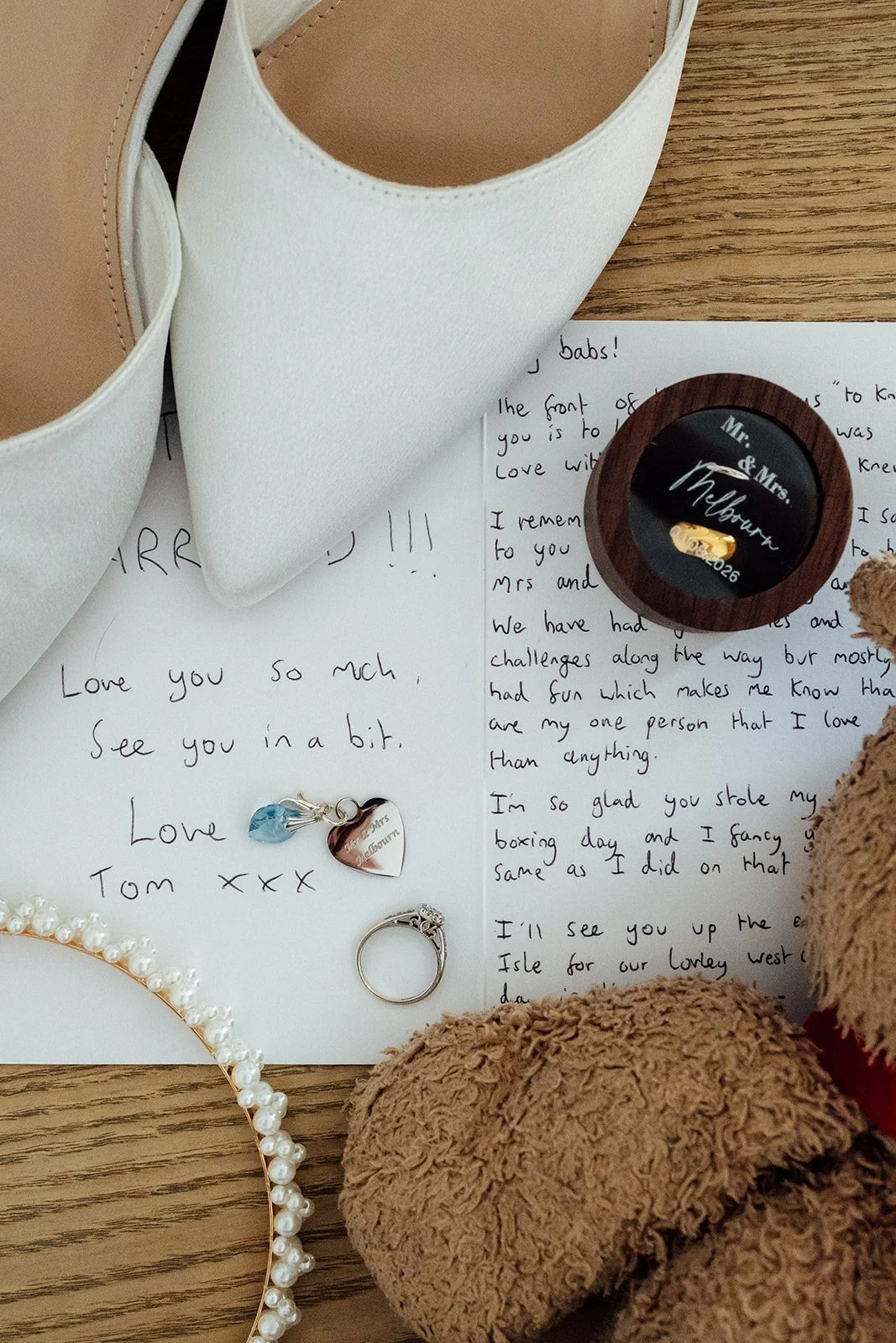 Elise and Tom’s wedding shoes, handwritten notes, rings and keepsakes arranged before their Bowerchalke Barn wedding in Wiltshire, photographed by Just James Weddings.