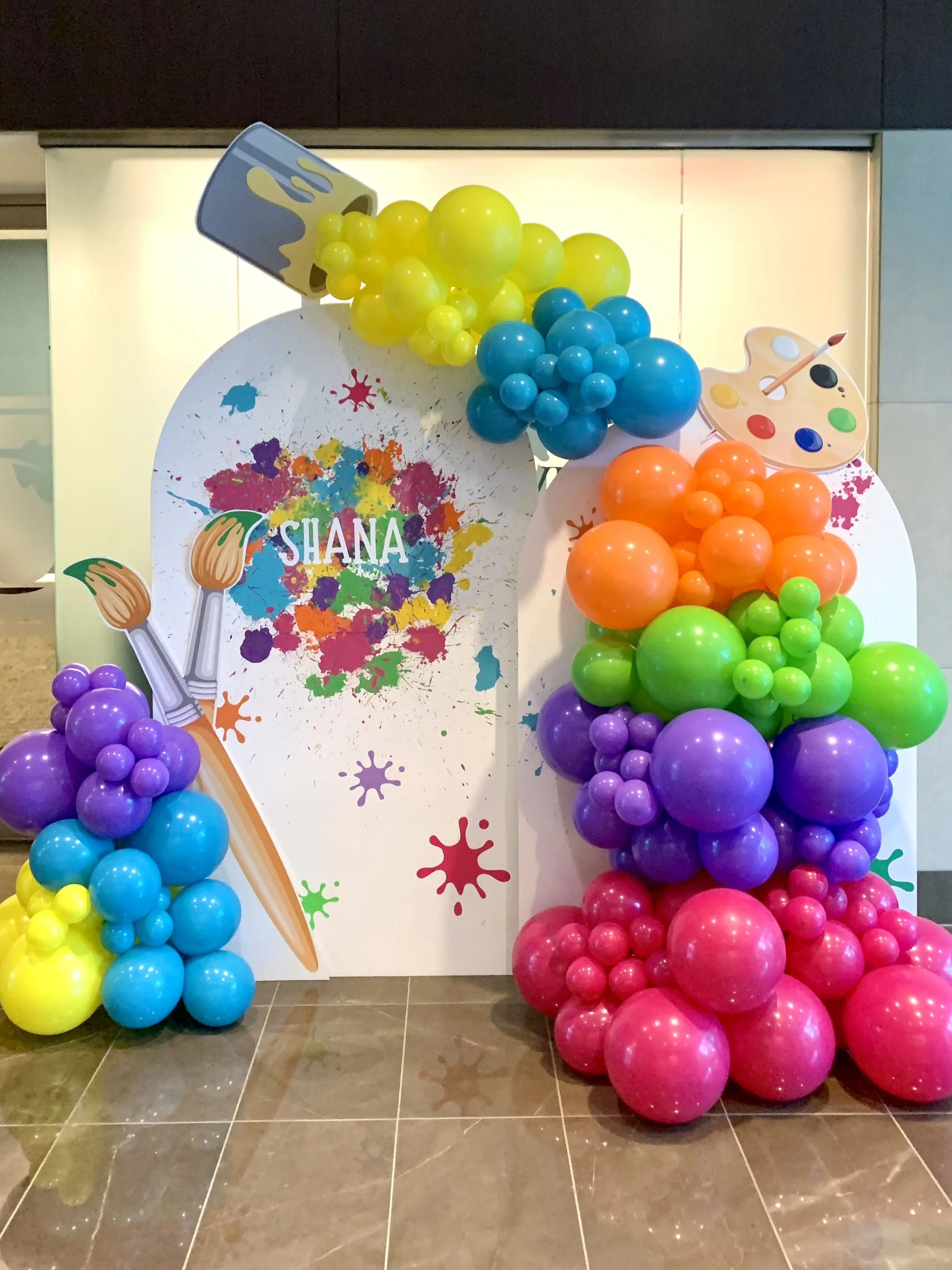 Custom designed artists balloon backdrop with giant paint brushes, paint bucket and painters pallet.