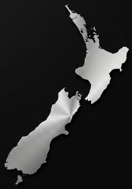 Silhouette of New Zealand made from a brushed metal material on a black background.