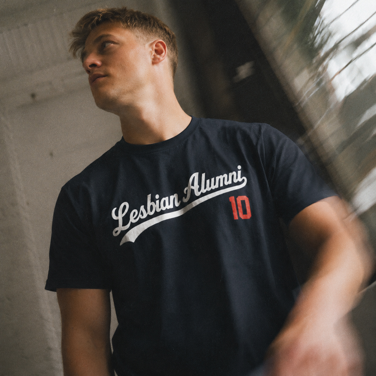 LA_LesbianAlumni_HomeTeam_Baseball_Tshirt_Lifestyle_Navy_Front.png