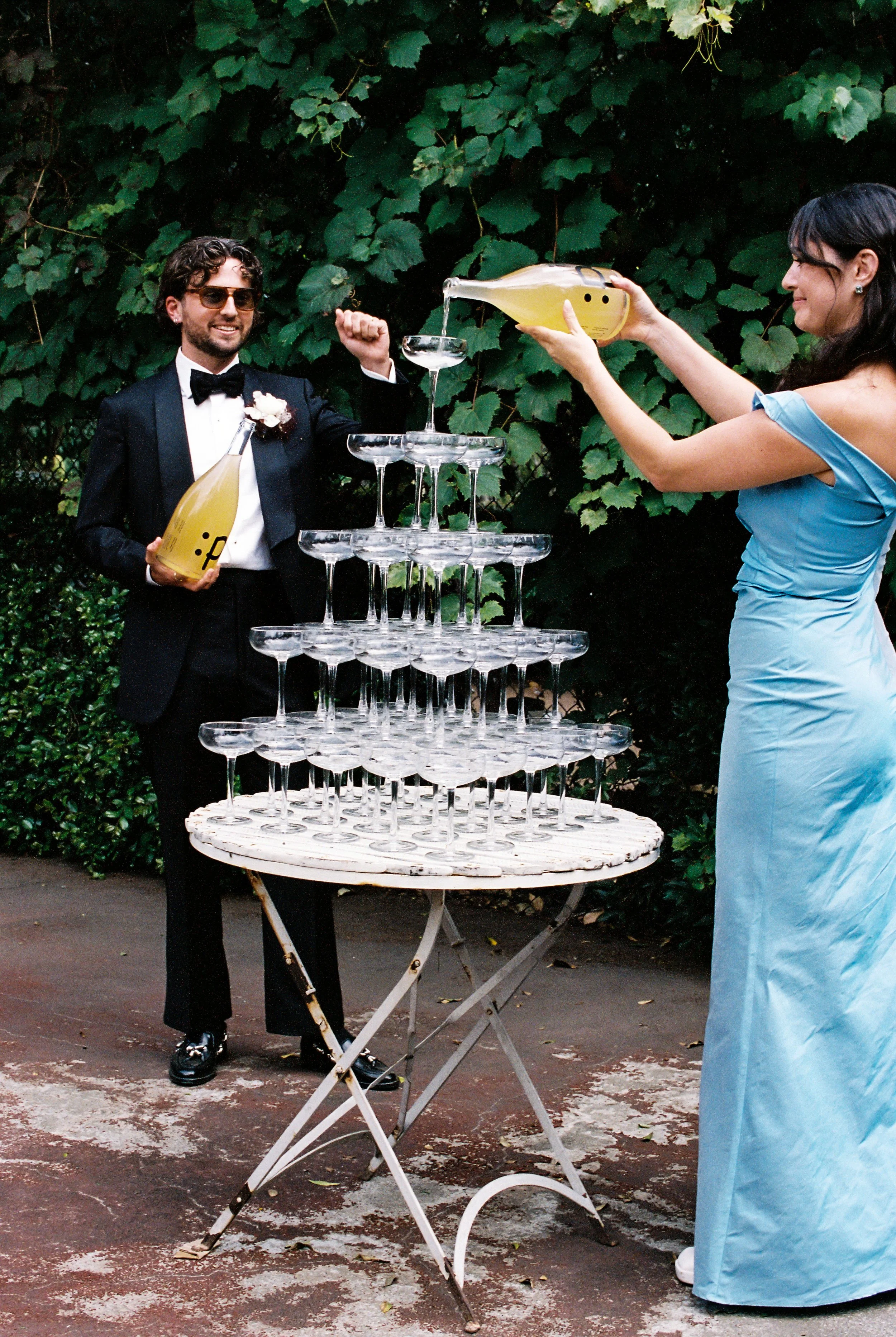 Champagne tower for wedding poured by b ride and groom