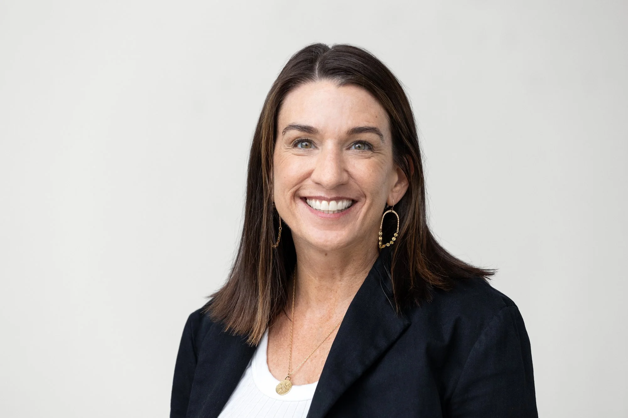 Headshot of Nikol Plass against a light gray background.