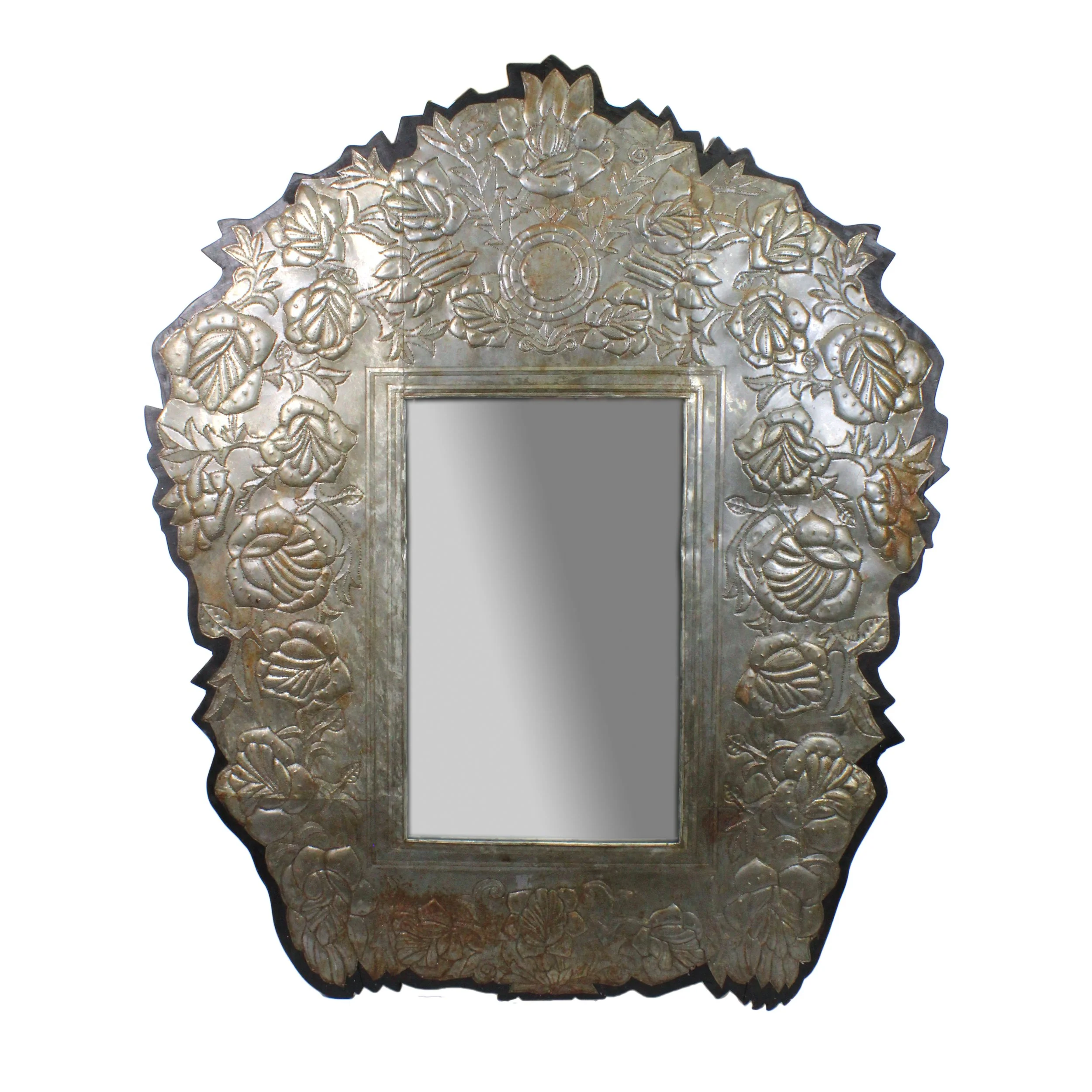 Mirror in large, silver frame with a thin black border. The frame has stamped flowers and vines and the edge is created by the jagged flower and leaf shapes. The tin shows age in places.