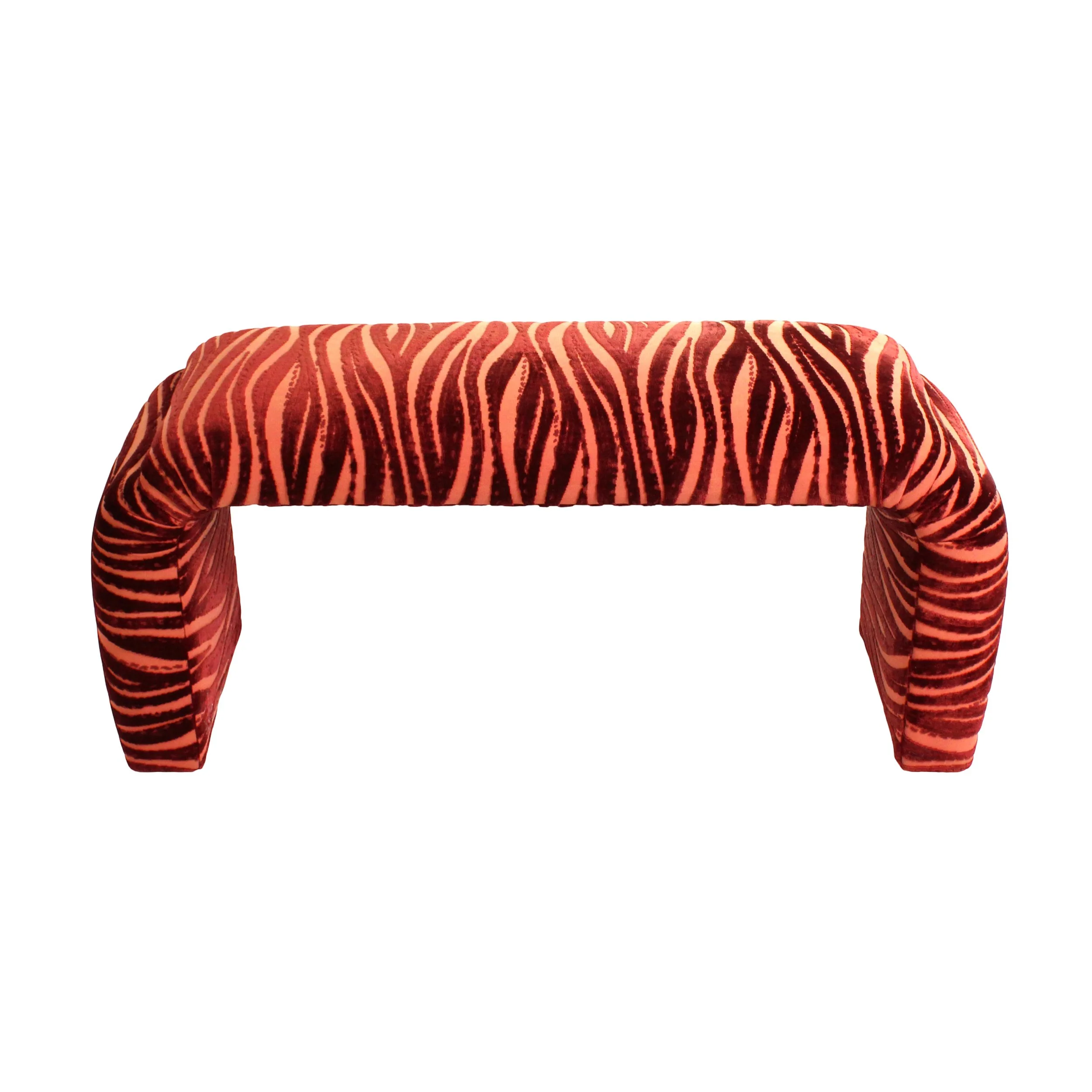 Long upholstered bench with fuzzy dark and light red zebra striped fabric