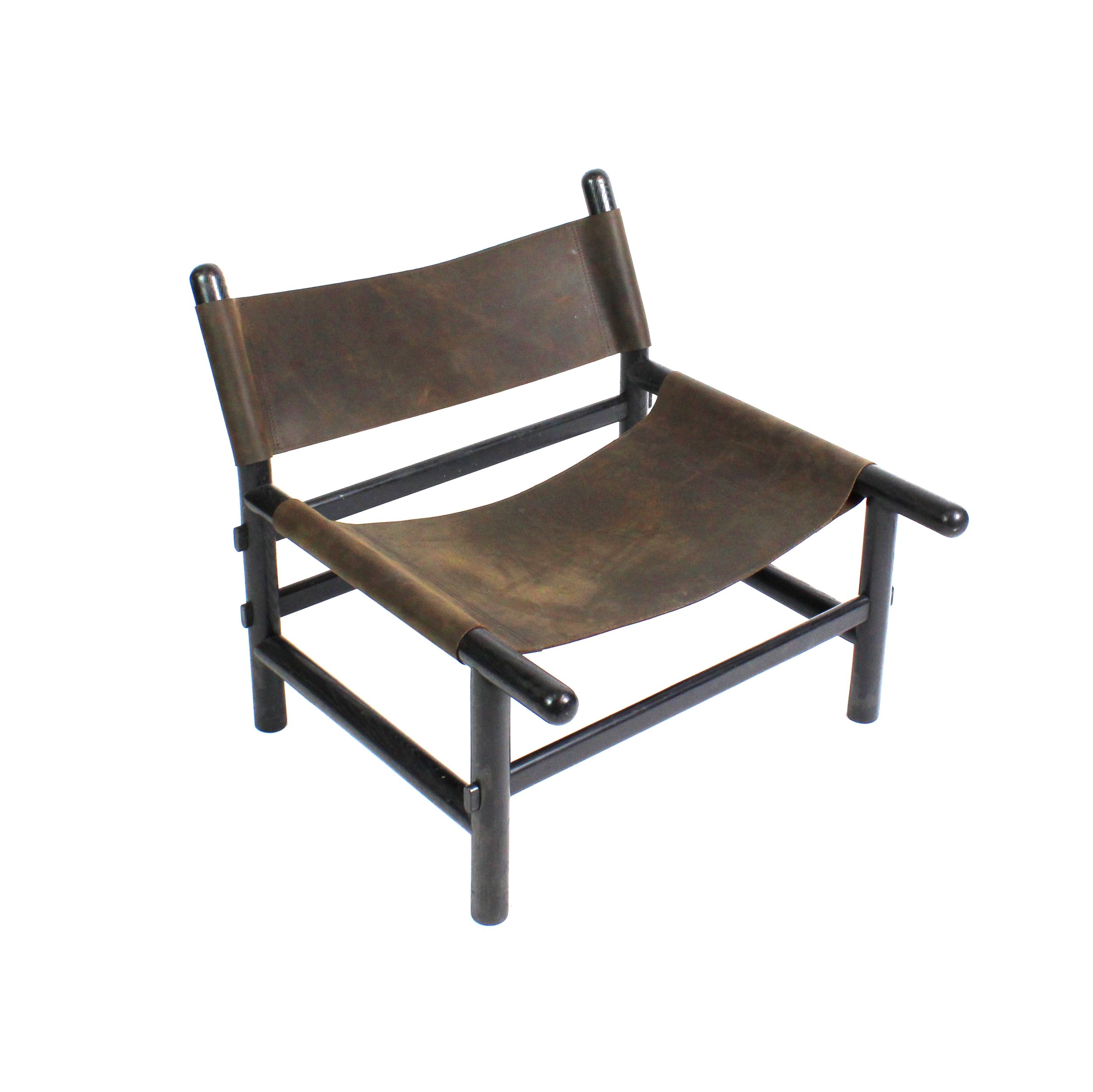 Low seated black wood framed chair with dark matte leather sling seat and back