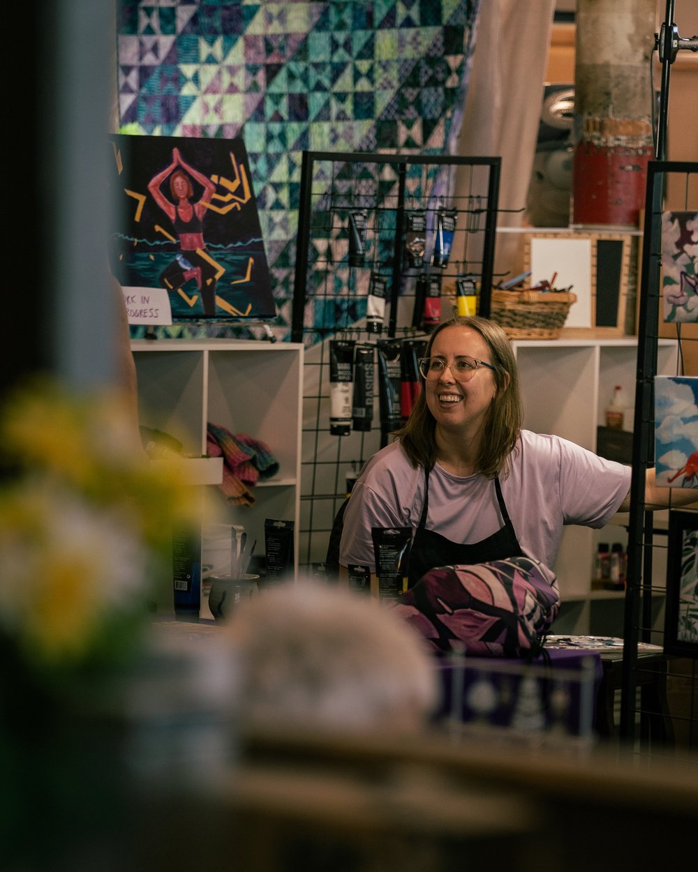 Artist Monica Brinkman in her studio, surrounded by her paintings