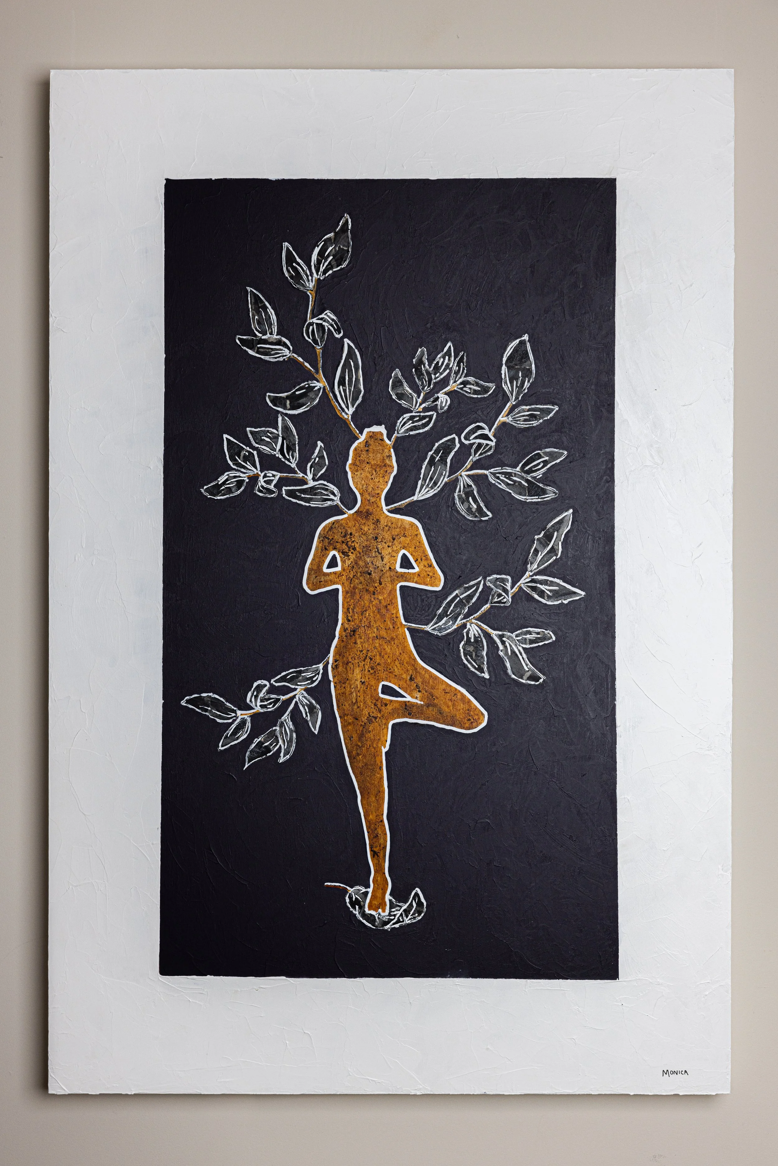 Silhouette of a person in tree pose surrounded by branches with leaves, on a black and white background.