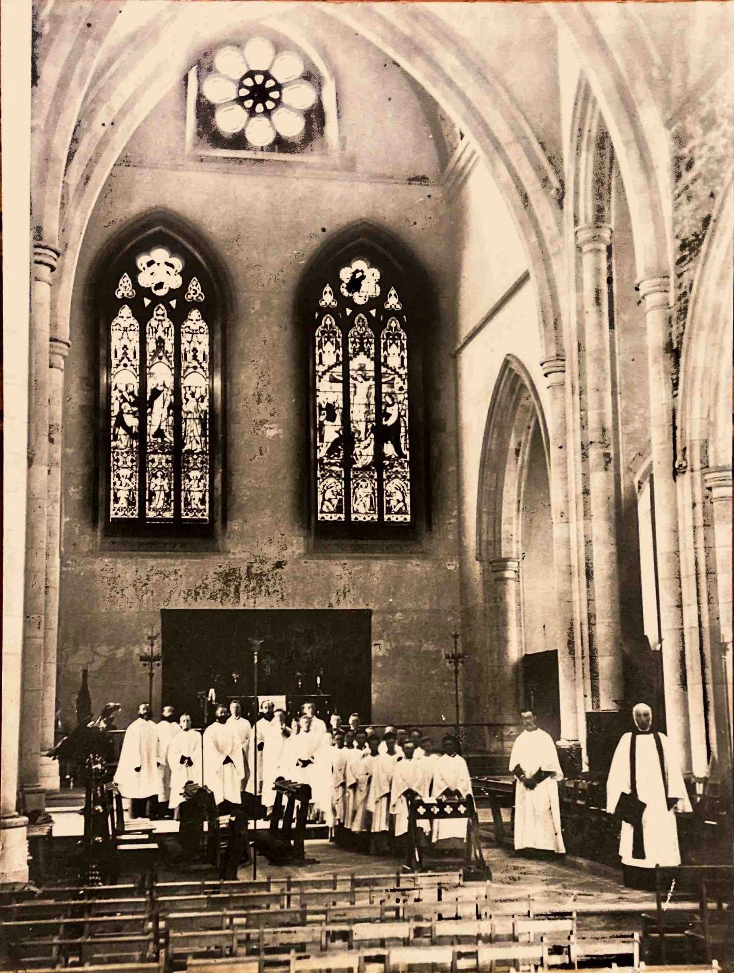 4. The Sanctuary circa 1878 - The choir is standing in the Chancel in front of the altar. The wall behind the altar was demolished circa 1902 when the apse was added. The two stained glass windows are now in other churches.
