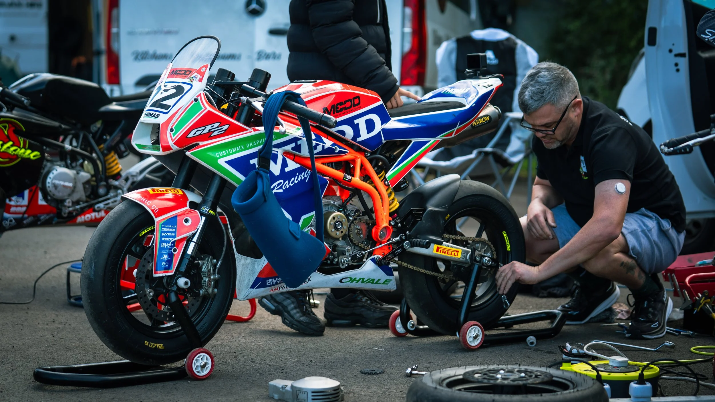 Father rigging a Supermoto ready for an event