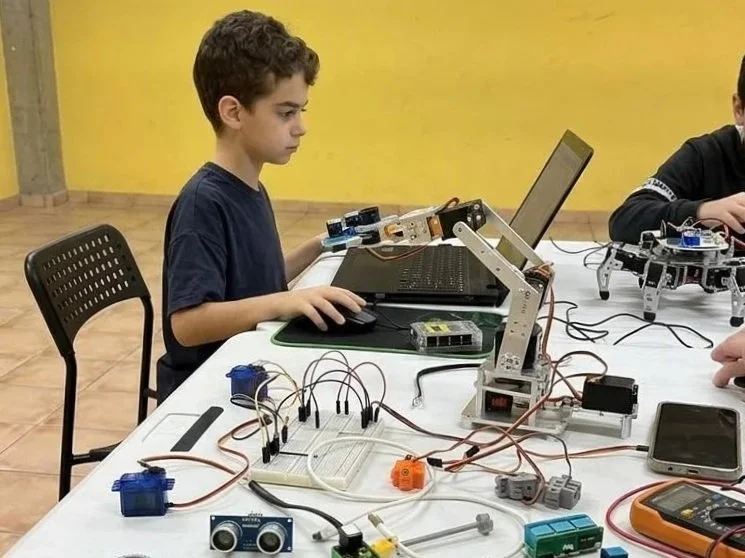 Student programming an electronics project on a laptop at Cranium